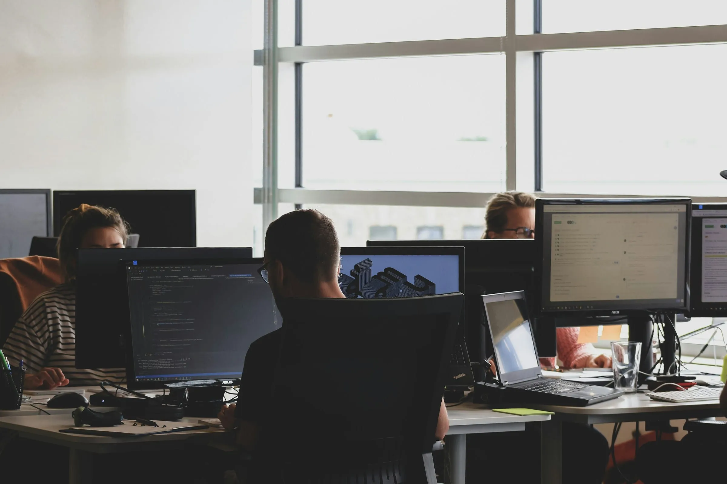 People working at computer screens in an office